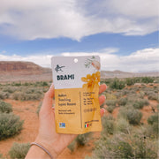 Hand holding Brami Lupini Beans Snack Garlic & Rosemary Single Serve