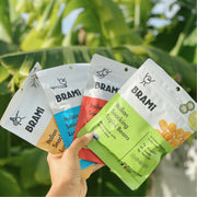 Hand holding four flavors of Brami lupini beans snacks