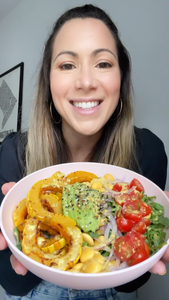 Woman reviewing Brami lupini bean snacks with salad bowl