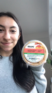 Woman reviewing Brami lupini bean dip