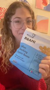 Woman reviewing Brami lupini bean snacks