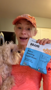 Woman reviewing Brami lupini bean snacks